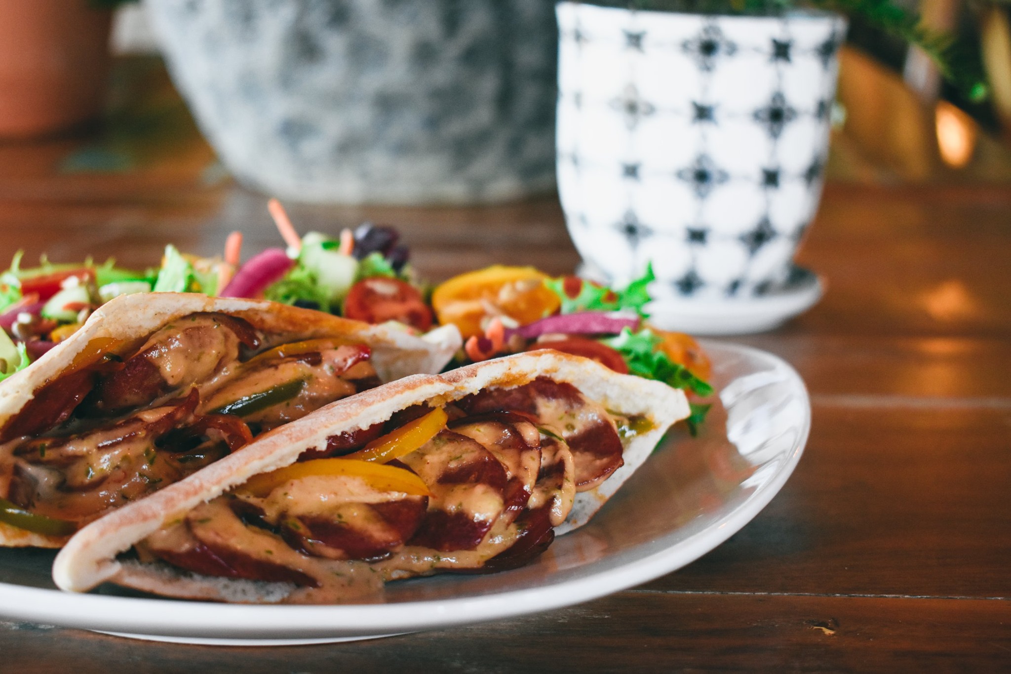 grab this cajun pita pocket with andouille sausage, peppers, onion, and a tangy remoulade for lunch. it's this week's slightly spicy special and pairs well with a simple garden salad, or with our shrimp gumbo.